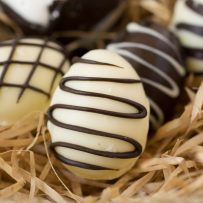 A white chocolate egg drizzled with dark chocolate
