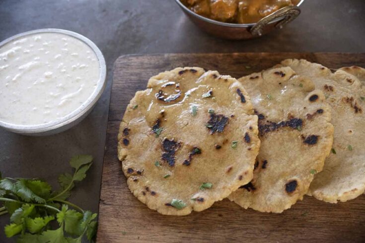 Naan bread pieces served with raita