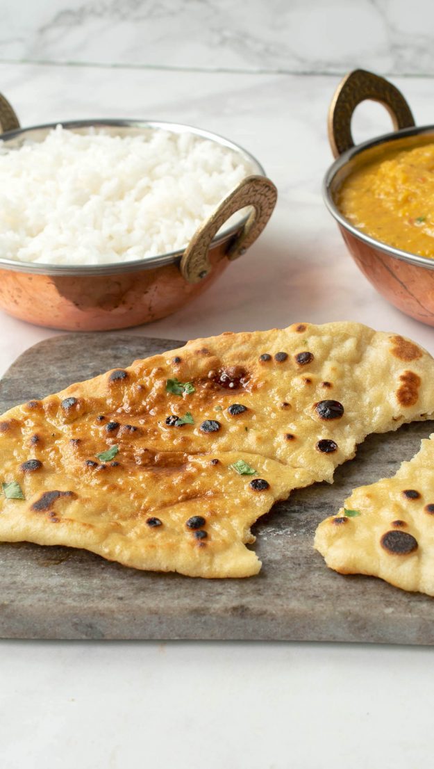 A piece of naan bread broken half