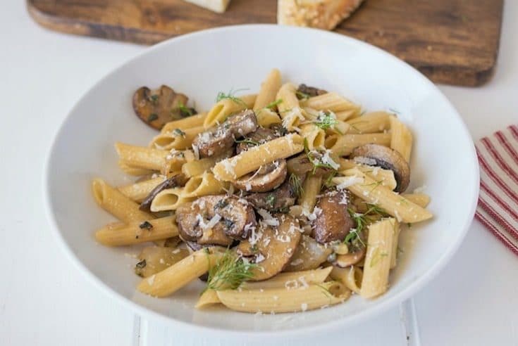 Dinner is served pasta, mushrooms, fennel and sage in a white bowl