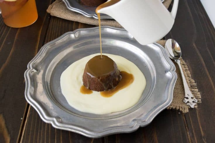 Sticky toffee pudding and English custard on a plate with toffee sauce