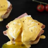 Runny egg yolk from a poached egg from eggs benedict