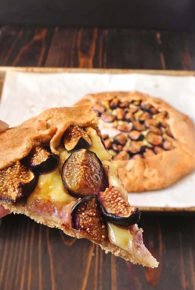 Holding a slice of fig and Brie Galette