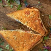 A grilled cheese sandwich cut into triangles viewed from overhead