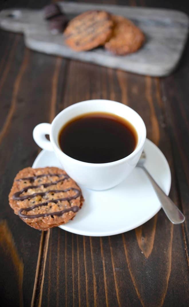 A Florentine cookie on the saucer of a cup of coffee