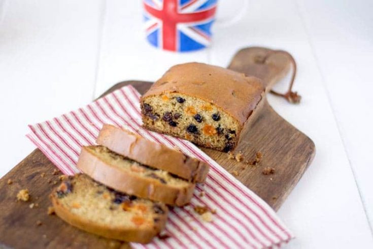 A tea cake cut showing the dried fruit inside