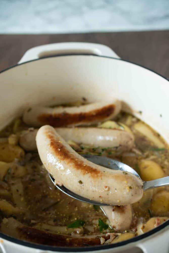 A Weisswurst (white sausage) on a ladle
