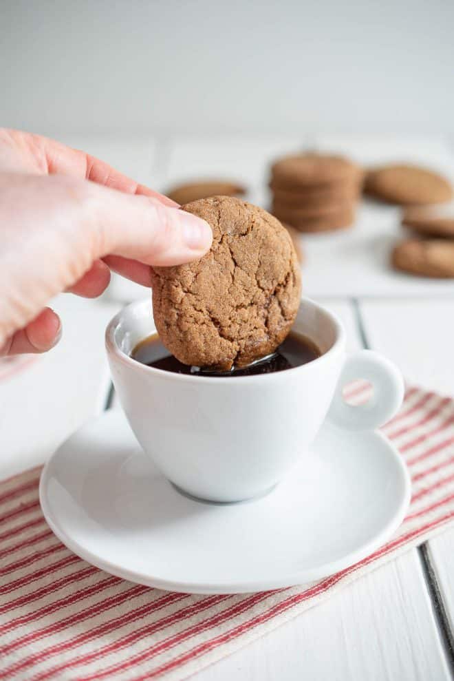 Dipping a cookie into a cup of coffee