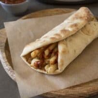 A naan wrapped around chips/French fries with Indian spiced ketchup