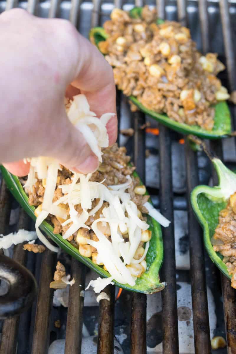 Add cheese to the beef stuffed poblano peppers
