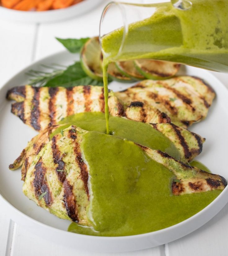 Perfectly grilled chicken with vibrant green herb sauce