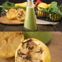 A bottle of salad dressing and a closeup of a grilled lemon cut in half