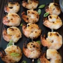 Shrimp kabob style on a slate serving plate