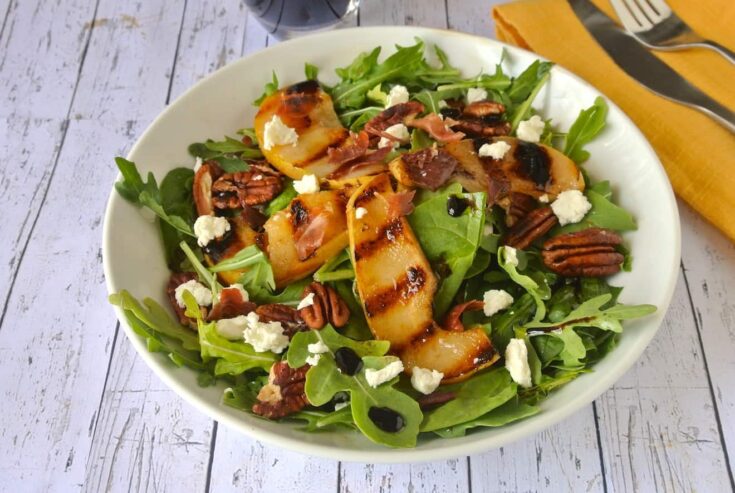 Pear and Crispy Prosciutto Salad ub a white bowl