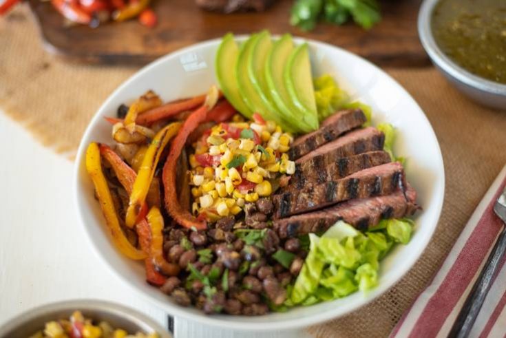 A fajita bowl in a white bowl ready to be eaten