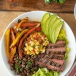 Grilled steak, slice with peppers, avocado, beans and corn