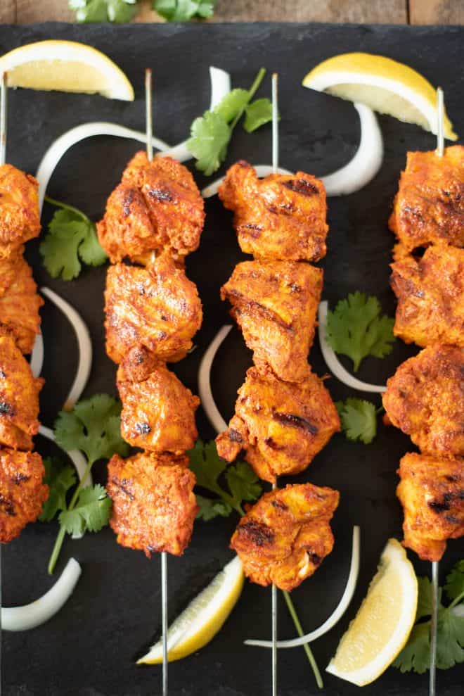 Grilled Tandoori Chicken Kebabs brings everyones favorite tandoori Indian dish into our own kitchens. Chicken is marinated in yogurt and &nbsp;delicious Indian spices then grilled to achieve the closest flavor you can get without a tandoor oven. #tandoorichicken #grilled #indian
