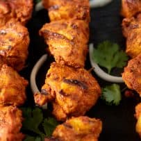 Perfectly grilled tandoori chicken on skewers