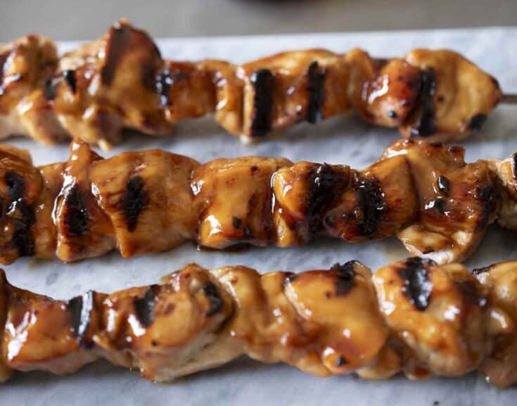 A closeup of charred and grilled chicken pieces
