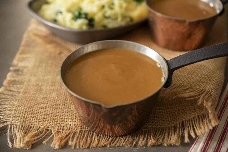 A small copper pot filled with gravy