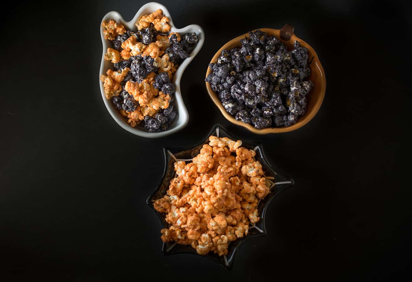 3 bowls of Halloween popcorn, some orange and some black