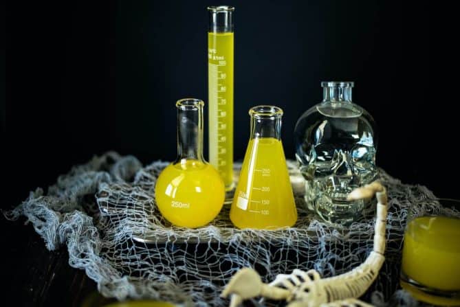 Science beakers are used as serving vessels for Halloween Scorpion Venom Punch