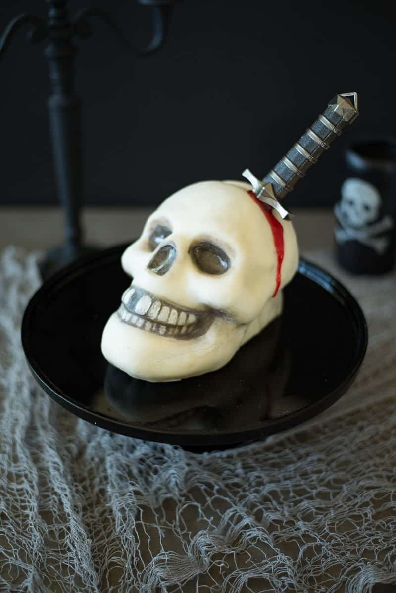 This Halloween skull and dagger cake is a fun spooky centerpiece that will be sure to scare any Halloween party goers. This cake can also serve as desserts for your guests, if you dare to eat it.