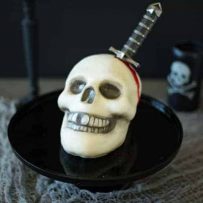 This Halloween skull and dagger cake is a fun and spooky centerpiece that will be sure to scare any Halloween partygoers. This cake can also serve as desserts for your guests, if they dare to eat it.