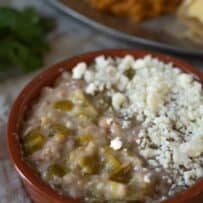 A closeup showing hatch green chiles in refried beans