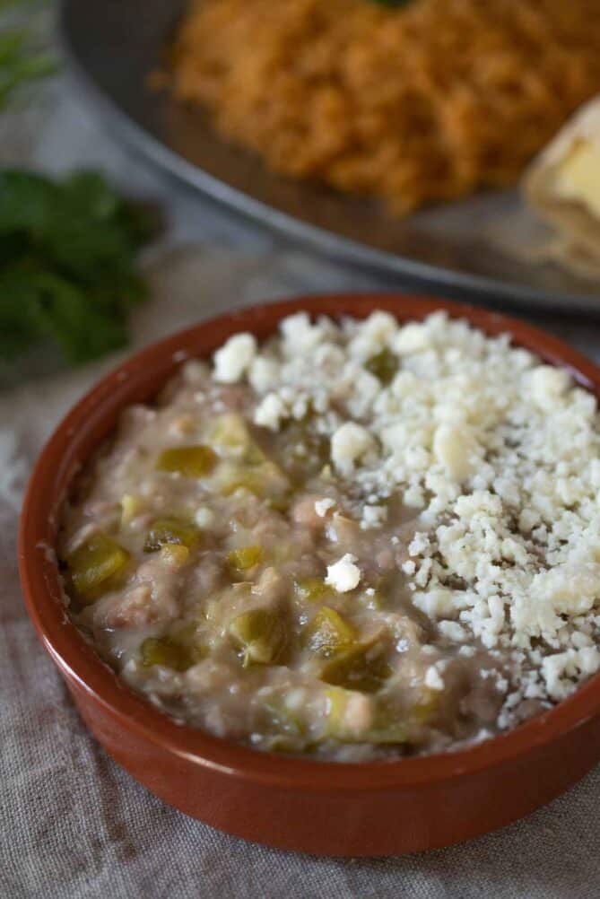 A closeup showing hatch green chiles in refried beans