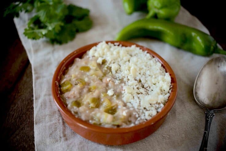 Refried beans mixed with hatch Chile peppers topped with crumbled cheese