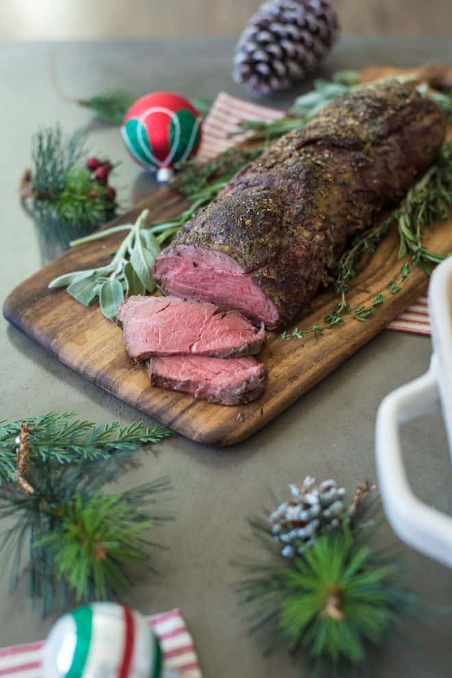 A whole beef tenderloin on a cutting board