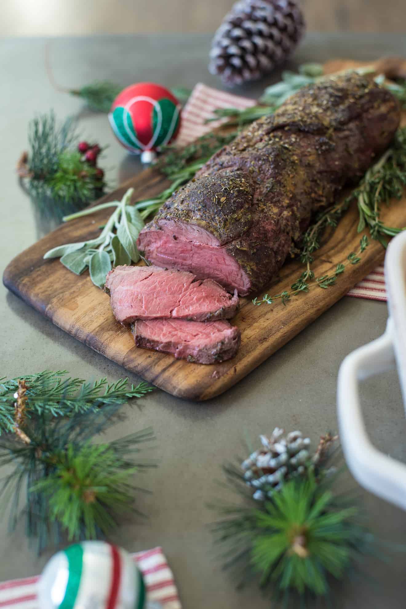 A whole beef tenderloin on a cutting board