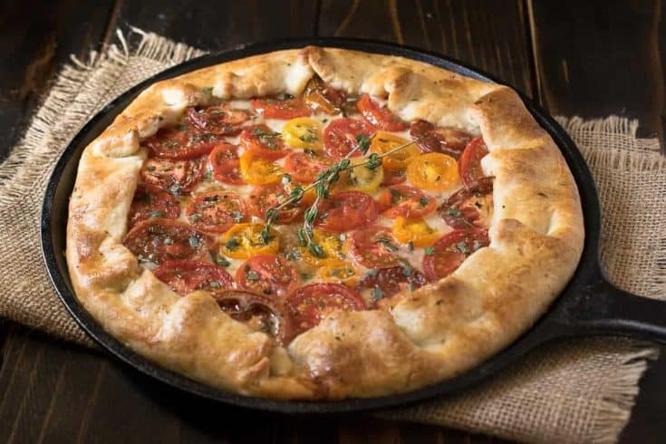 Herbed tomato galette served in a cast iron skillet