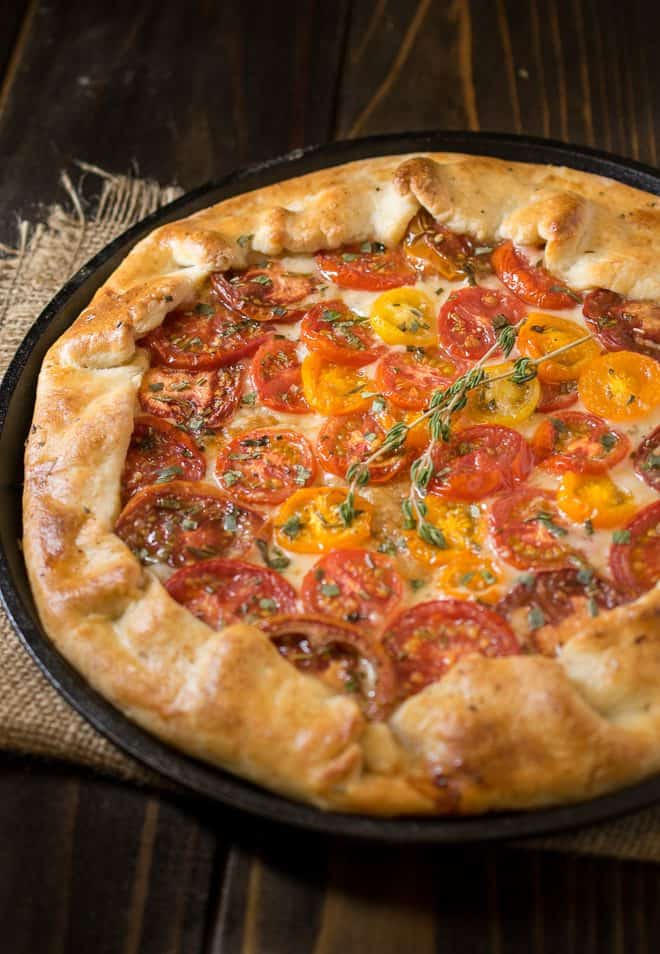 Herbed tomato galette using red and yellow tomatoes garnished with fresh herbs