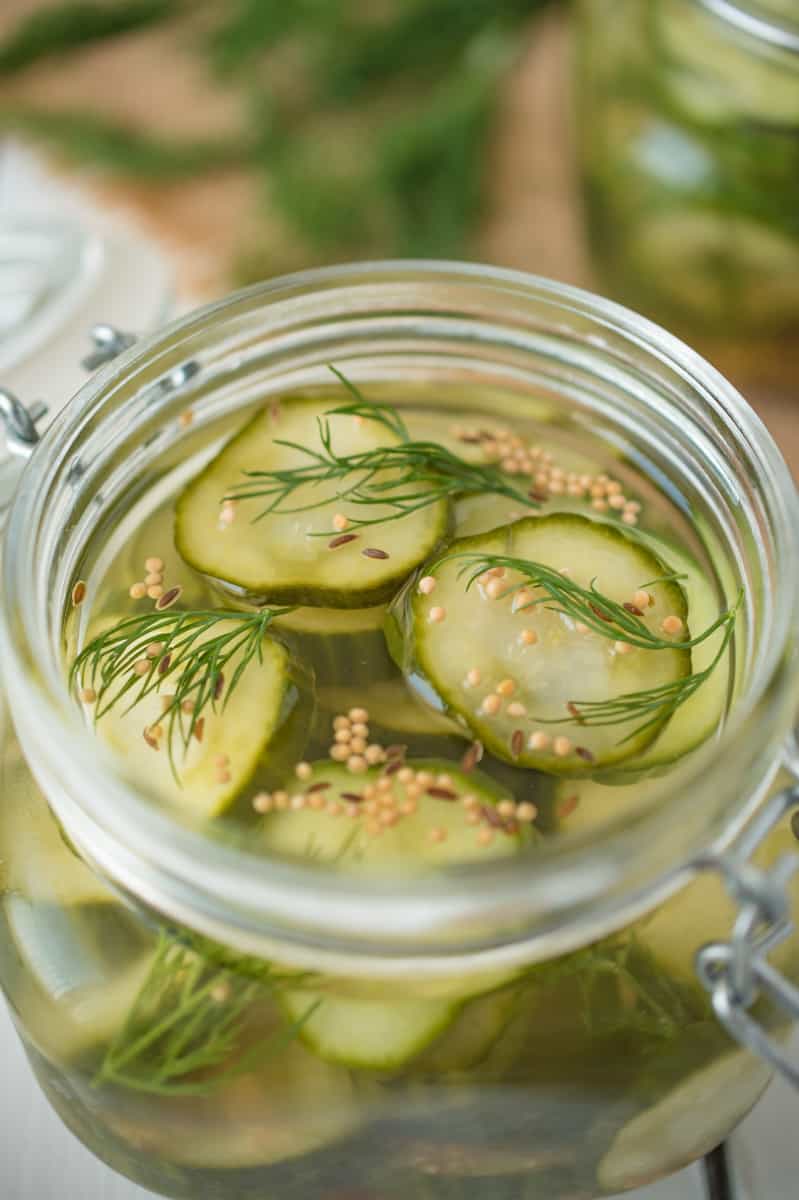 A closeup showing the cucumber slices, fresh dill and pickling spices