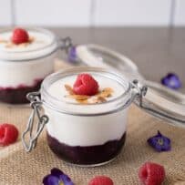 A glass jar filled with yogurt and fruit