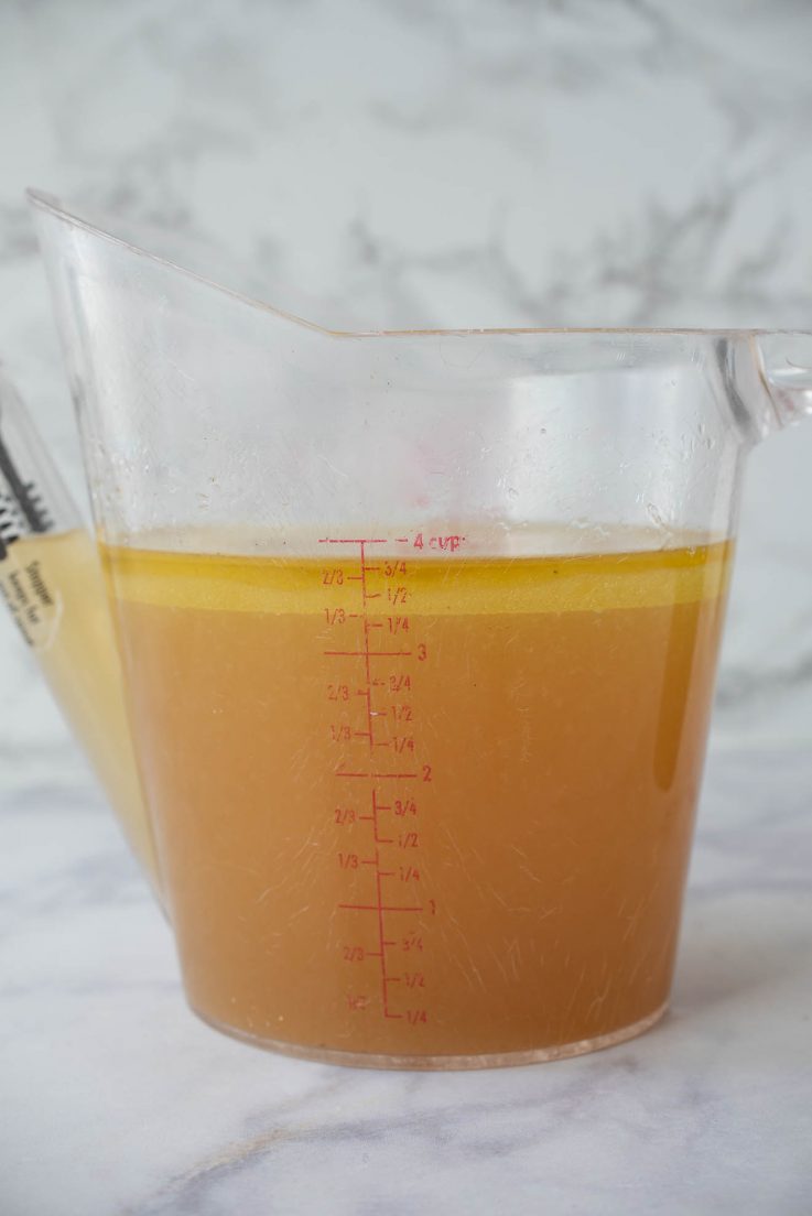 A jug filled with chicken broth