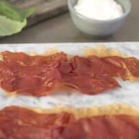 A closeup of a slice of prosciutto