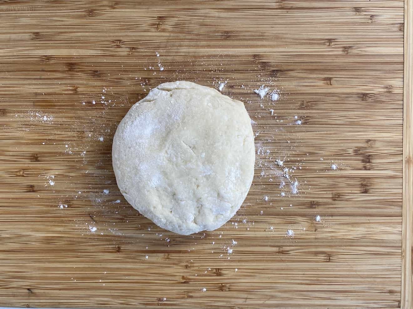 A ball of potato dough on a board