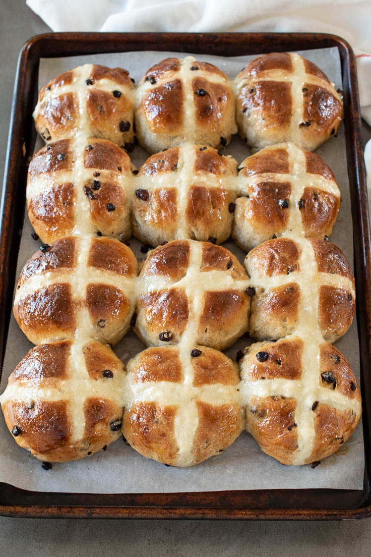 Hot cross buns on a baking tray