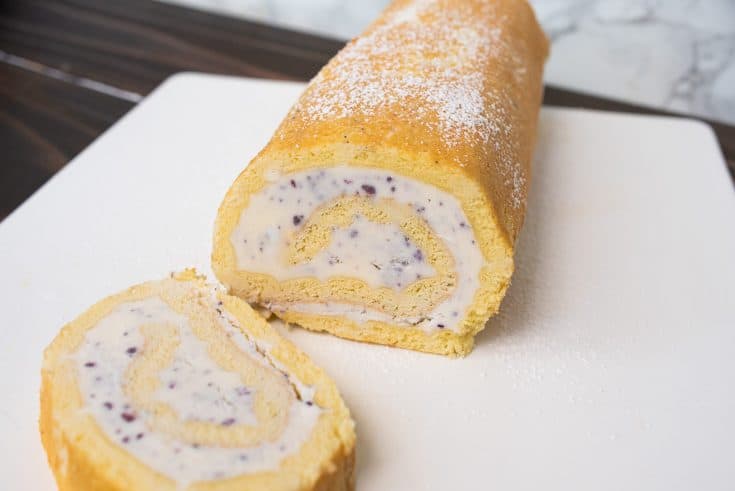 Blueberry and strawberry swirled ice cream rolled in a yellow sponge cake