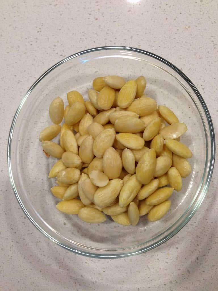 A bowl full of peeled almonds