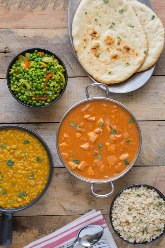 Chicken tikka masala, peas and vegetables, dal, naan bread and rice