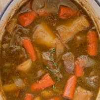 An oval Dutch oven filled with beef stew