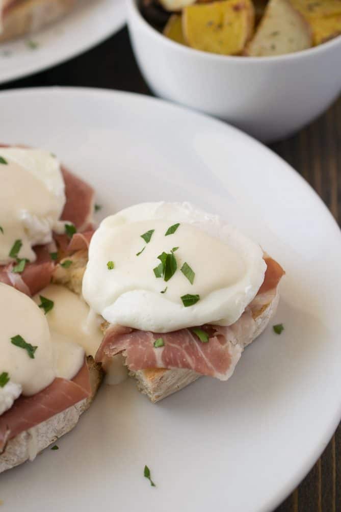 An Italian eggs Benedict on a white plate