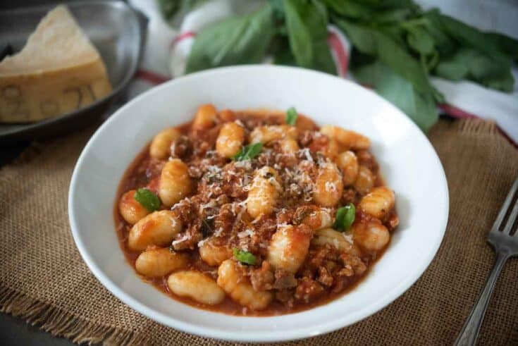 Chunky meat in tomato sauce mixed with gnocchi