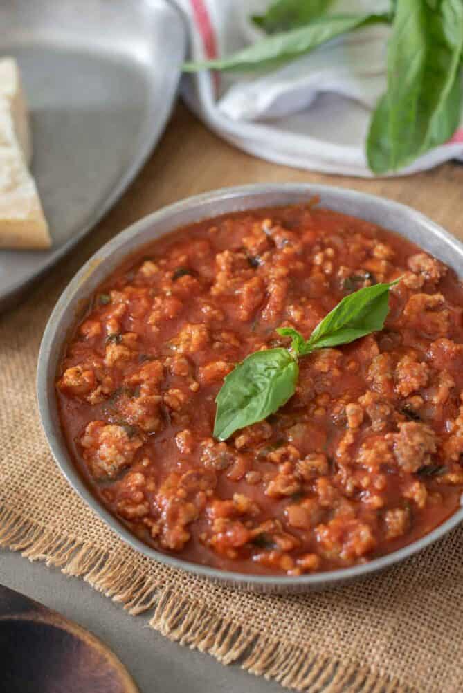 Italian Sausage Ragu di Salsiccia in a pan with basil leaves