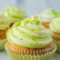 Green and white swirled cream cheese frosting on top of a cupcake