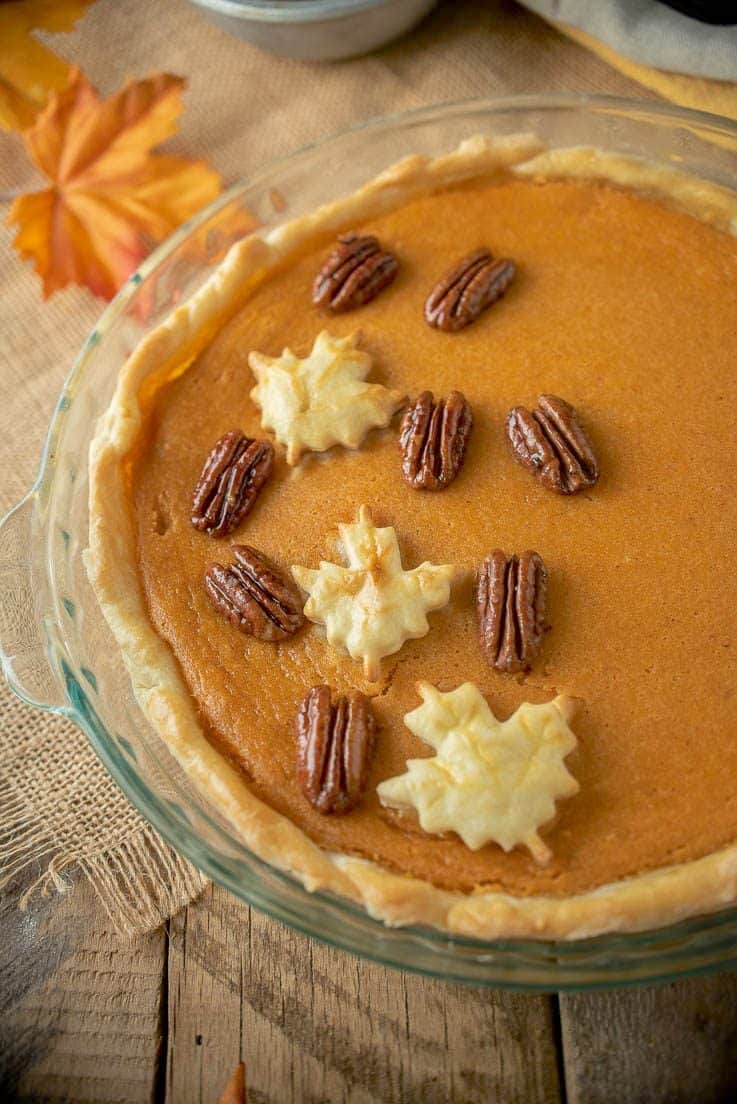 Pastry maple leaves and maple glazed pecans decorate the top of the pie